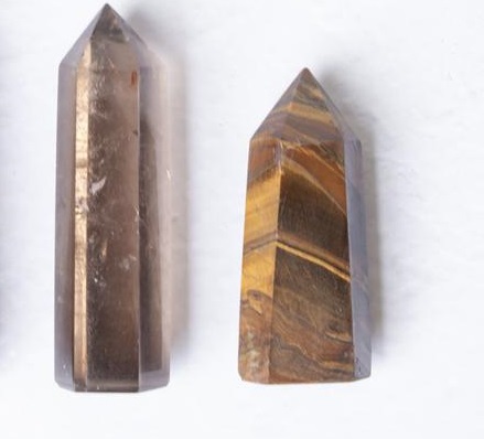 Smoky Quartz and Tiger's Eye crystals next to each other, a pair of conflicting crystals.
